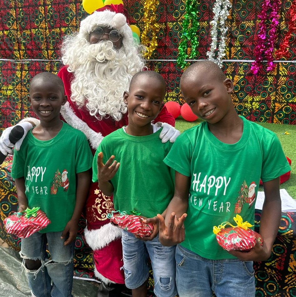 A group of students and their families celebrating at the annual Zoe Robinson Academy Christmas party.